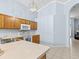 Kitchen with light wood cabinets, white appliances, and tile floor at 164 Sevilla Ave, Davenport, FL 33897