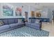 Spacious living area with blue sofas and a view into the kitchen at 164 Sevilla Ave, Davenport, FL 33897