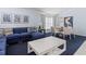 Open living and dining area with a comfortable sectional sofa and round dining table at 164 Sevilla Ave, Davenport, FL 33897
