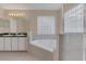 Primary bathroom with double vanity, corner tub and shower at 16946 Woodcrest Way, Clermont, FL 34714