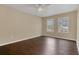 Simple bedroom with dark wood flooring and neutral walls at 16946 Woodcrest Way, Clermont, FL 34714