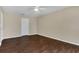 Spacious bedroom with dark wood flooring and neutral walls at 16946 Woodcrest Way, Clermont, FL 34714