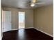 Main bedroom with dark hardwood floors and ensuite bathroom at 16946 Woodcrest Way, Clermont, FL 34714