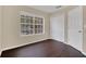 Spacious bedroom with dark wood floors and a large window at 16946 Woodcrest Way, Clermont, FL 34714