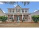 Two-story house with brick and siding, front porch, and landscaping at 16946 Woodcrest Way, Clermont, FL 34714