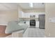 Kitchen with white cabinets, stainless steel appliances, and a breakfast bar at 16946 Woodcrest Way, Clermont, FL 34714