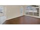 Bright living room with dark laminate floors and backyard view at 16946 Woodcrest Way, Clermont, FL 34714