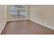 Living room with arched window and dark hardwood floors at 16946 Woodcrest Way, Clermont, FL 34714