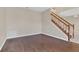 Living room with dark hardwood floors and a staircase at 16946 Woodcrest Way, Clermont, FL 34714