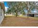 Large backyard with mature trees and neighborhood view at 1741 Palmerston Cir, Ocoee, FL 34761