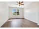 Spacious bedroom featuring a ceiling fan and large window at 1741 Palmerston Cir, Ocoee, FL 34761