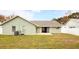 View of the backyard and the back of the home with a sliding glass door at 1747 Lady Slipper Cir, Orlando, FL 32825