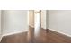 Bright bedroom with dark wood-look floors and door to hallway at 1747 Lady Slipper Cir, Orlando, FL 32825