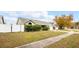 Green house exterior with a white fence and large tree in the background at 1747 Lady Slipper Cir, Orlando, FL 32825