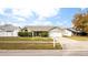 One-story house with green siding, attached garage, and landscaped yard at 1747 Lady Slipper Cir, Orlando, FL 32825
