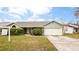 Single-story house with a green exterior and a two-car garage at 1747 Lady Slipper Cir, Orlando, FL 32825