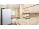 Kitchen with light cabinets, granite countertops, and a window at 1747 Lady Slipper Cir, Orlando, FL 32825
