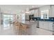 Modern kitchen with stainless steel appliances, white cabinets, and blue tile backsplash at 2337 Daisy Tree Rd, St Cloud, FL 34771