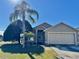Single-story house with a two-car garage and palm tree in front at 2864 Copper Ridge Ct, Lake Mary, FL 32746