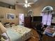 Main bedroom with floral bedding and home office area at 2864 Copper Ridge Ct, Lake Mary, FL 32746