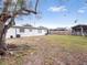 Large backyard with grass and mature trees at 2911 Dudley Dr, Bartow, FL 33830