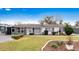 Ranch-style home with gray accents, well-manicured lawn, and mature trees at 2911 Dudley Dr, Bartow, FL 33830