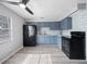 Updated kitchen with blue cabinets, black appliances, and vinyl flooring at 2911 Dudley Dr, Bartow, FL 33830