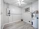 Laundry room with vinyl flooring, water heater, and electrical panel at 2911 Dudley Dr, Bartow, FL 33830