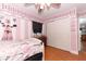 Pink and black Parisian themed bedroom with hardwood floors and sliding door closet at 355 Carriage Way Ct, Oviedo, FL 32765