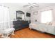 Bedroom with a grey dresser, rocking chair, and light grey bedding at 355 Carriage Way Ct, Oviedo, FL 32765