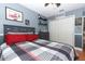 Grey and red themed bedroom with hardwood floors and a grey dresser at 355 Carriage Way Ct, Oviedo, FL 32765