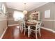 Bright dining room with hardwood floors, a wooden table, and white hutch at 355 Carriage Way Ct, Oviedo, FL 32765