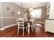 Farmhouse-style dining room with hardwood floors, a long table, and white chairs at 355 Carriage Way Ct, Oviedo, FL 32765
