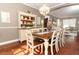 Bright dining room features a rustic farmhouse table with seating for six at 355 Carriage Way Ct, Oviedo, FL 32765