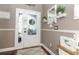 Bright entryway with hardwood floors, white door, and decorative wall accents at 355 Carriage Way Ct, Oviedo, FL 32765