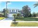 Two-story house with gray siding, landscaping, and a white garage door at 355 Carriage Way Ct, Oviedo, FL 32765