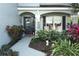 Home entrance with a charming porch, landscaping, and a walkway at 355 Carriage Way Ct, Oviedo, FL 32765