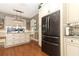 View of kitchen with stainless steel refrigerator and granite countertops at 355 Carriage Way Ct, Oviedo, FL 32765