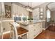 Kitchen features a large island with seating and a farmhouse chandelier at 355 Carriage Way Ct, Oviedo, FL 32765