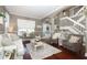 Spacious living room featuring hardwood floors, neutral decor, and comfy seating at 355 Carriage Way Ct, Oviedo, FL 32765