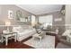Living area with hardwood floors, white couch, and farmhouse-style decor at 355 Carriage Way Ct, Oviedo, FL 32765