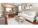 Open living space with hardwood floors, white couch, and view to dining area at 355 Carriage Way Ct, Oviedo, FL 32765