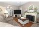 Bright living room boasts a fireplace and large TV at 355 Carriage Way Ct, Oviedo, FL 32765