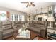 Spacious living room with a large brown sectional sofa and coffee table at 355 Carriage Way Ct, Oviedo, FL 32765