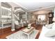 Open concept living area with hardwood floors, neutral decor, and staircase at 355 Carriage Way Ct, Oviedo, FL 32765