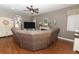 Living room with sectional sofa, fireplace and wood floors at 355 Carriage Way Ct, Oviedo, FL 32765
