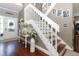 Elegant staircase with white railings and hardwood floors at 355 Carriage Way Ct, Oviedo, FL 32765