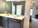 Double vanity bathroom with gray cabinets at 3653 Yarian Dr, Haines City, FL 33844