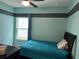 Bedroom with teal walls, a double bed, and a window at 3653 Yarian Dr, Haines City, FL 33844
