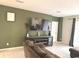 Living room with large TV and green accent wall at 3653 Yarian Dr, Haines City, FL 33844